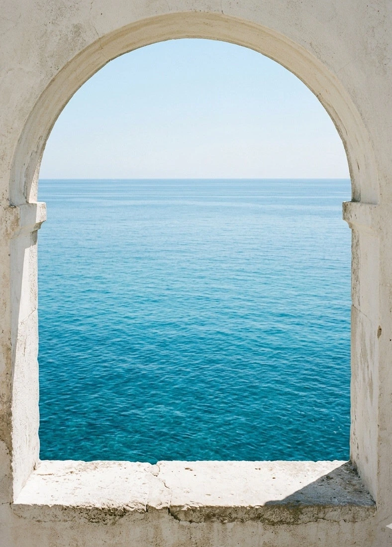 A stone arch framing gently rippling turquoise water